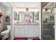Well-lit bathroom with dual sinks, ample counter space, and a glass-enclosed shower stall at 3407 Melbourne Ln, The Villages, FL 32163
