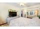 Bedroom with mirrored closet doors, ceiling fan, and neutral colored walls at 3407 Melbourne Ln, The Villages, FL 32163