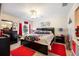 Comfortable bedroom featuring a ceiling fan, black furniture set, and red accent rugs at 3407 Melbourne Ln, The Villages, FL 32163
