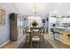 Charming dining room features a table set for six, a display cabinet, and views into the kitchen at 3407 Melbourne Ln, The Villages, FL 32163