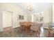 Bright dining room with neutral colors, a vaulted ceiling, and a modern light fixture at 3407 Melbourne Ln, The Villages, FL 32163