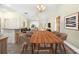 Open-concept dining room with sleek table, bar seating, and seamless flow to the living area at 3407 Melbourne Ln, The Villages, FL 32163
