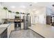 Well-maintained kitchen with white cabinets, stainless steel appliances, tile floors, and ample counter space for food preparation at 3407 Melbourne Ln, The Villages, FL 32163