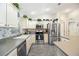 Classic kitchen with white cabinets, stainless steel appliances, and neutral countertops, offering a functional and timeless design at 3407 Melbourne Ln, The Villages, FL 32163
