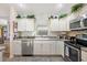 Bright kitchen features white cabinets, stainless steel appliances, and a functional layout, perfect for cooking and entertaining at 3407 Melbourne Ln, The Villages, FL 32163