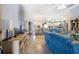 Open-concept living space with modern furnishings, tiled floors, and a seamless flow to the kitchen at 3407 Melbourne Ln, The Villages, FL 32163