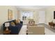 Bright living room with vaulted ceilings, neutral paint, large windows, and modern furnishings at 3407 Melbourne Ln, The Villages, FL 32163