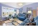 Cozy living room featuring a large window and comfortable blue furnishings at 3407 Melbourne Ln, The Villages, FL 32163