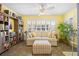 Bright living room featuring shuttered windows, a sofa with an ottoman, and built-in shelves at 3407 Melbourne Ln, The Villages, FL 32163