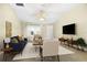 Bright living room with vaulted ceilings, neutral paint, large windows, and modern furnishings at 3407 Melbourne Ln, The Villages, FL 32163
