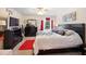 Comfortable bedroom features a ceiling fan, coordinated furnishings, and a view to the outside at 3407 Melbourne Ln, The Villages, FL 32163