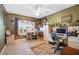 Inviting home office featuring dual work stations, neutral decor, and ample natural light from a large window at 3407 Melbourne Ln, The Villages, FL 32163