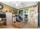 Functional home office with computer desks, storage, natural light, and a view into the hallway at 3407 Melbourne Ln, The Villages, FL 32163