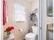 Neat and tidy powder room with decorative accents, fresh flowers, and a window with natural light at 3407 Melbourne Ln, The Villages, FL 32163