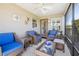 Enclosed sunroom with wicker furniture and a view of the landscaped backyard at 3407 Melbourne Ln, The Villages, FL 32163