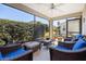 Enclosed sunroom with wicker furniture and a view of the landscaped backyard at 3407 Melbourne Ln, The Villages, FL 32163