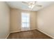 Carpeted bedroom showcasing a window with sheer curtains and neutral walls at 4421 Sw 139 Pl, Ocala, FL 34473