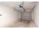 Spacious garage featuring concrete flooring, white walls, and a gray garage door at 4421 Sw 139 Pl, Ocala, FL 34473