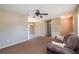 Living room view featuring carpet flooring, and a ceiling fan at 4421 Sw 139 Pl, Ocala, FL 34473