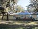 Spacious backyard featuring a deck with outdoor seating, perfect for relaxing and enjoying the outdoors at 4510 Se 183Rd Avenue Rd, Ocklawaha, FL 32179