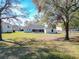 View of home from lawn shows fenced backyard with screened patio at 4541 Se 30Th St, Ocala, FL 34480
