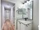 Bathroom features granite countertop, a white vanity, and a large mirror with modern lighting at 4541 Se 30Th St, Ocala, FL 34480