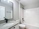 Bathroom features granite countertop, a white vanity, and a tub/shower combo with white tile surround at 4541 Se 30Th St, Ocala, FL 34480