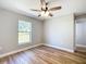 Bright bedroom features wood-look flooring, a window, and neutral paint at 4541 Se 30Th St, Ocala, FL 34480