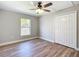 Bedroom features wood-look flooring, a ceiling fan, a window, and a closet with bi-fold doors at 4541 Se 30Th St, Ocala, FL 34480
