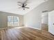 Bright bedroom with ceiling fan, wood floors, and large window allowing ample natural light at 4541 Se 30Th St, Ocala, FL 34480