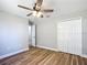 Bedroom features wood-look flooring, a ceiling fan, and a closet with bi-fold doors at 4541 Se 30Th St, Ocala, FL 34480