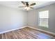 Comfortable bedroom with wood floors and natural light from the window at 4541 Se 30Th St, Ocala, FL 34480