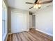 Bright bedroom features wood-look flooring, a ceiling fan, and a closet with bi-fold doors at 4541 Se 30Th St, Ocala, FL 34480