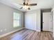Cozy bedroom with ceiling fan, closet, and wood floors at 4541 Se 30Th St, Ocala, FL 34480