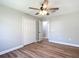 Bedroom features wood-look flooring, a ceiling fan, and a closet with bi-fold doors at 4541 Se 30Th St, Ocala, FL 34480
