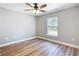 Bedroom features wood-look flooring, a window, and neutral paint at 4541 Se 30Th St, Ocala, FL 34480