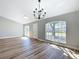 Spacious living room with elegant chandelier, wood flooring, and plenty of natural light at 4541 Se 30Th St, Ocala, FL 34480