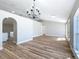 Open concept living room showcasing modern lighting, arched doorway and wood flooring at 4541 Se 30Th St, Ocala, FL 34480