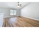 Living room boasts wood flooring, neutral decor, ceiling fan, and natural light at 4541 Se 30Th St, Ocala, FL 34480