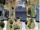 Aerial view of a well-maintained home featuring a screened pool, patio, and mature trees at 5037 Sw 109Th Loop, Ocala, FL 34476