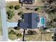 Aerial view showcases a home with a screened pool, updated roof, and landscaped front yard at 5037 Sw 109Th Loop, Ocala, FL 34476