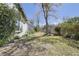 Spacious backyard with green grass, mature trees, and lush landscaping creating a serene outdoor space at 5037 Sw 109Th Loop, Ocala, FL 34476