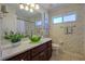 Bathroom featuring a vanity, large mirror, green accents, and leafy wallpaper at 5037 Sw 109Th Loop, Ocala, FL 34476