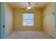Bedroom with carpeting, a ceiling fan, and a large window providing plenty of natural light at 5037 Sw 109Th Loop, Ocala, FL 34476