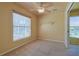 Bedroom with a ceiling fan, carpeted floors, and a window that fills the room with natural light at 5037 Sw 109Th Loop, Ocala, FL 34476