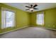 Bedroom with carpet, ceiling fan, and two windows at 5037 Sw 109Th Loop, Ocala, FL 34476