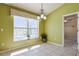 Bright dining area with tile flooring, a large window overlooking the pool, and natural light at 5037 Sw 109Th Loop, Ocala, FL 34476