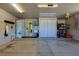Tidy garage featuring large storage cabinet, utility sink, and access to laundry and additional storage at 5037 Sw 109Th Loop, Ocala, FL 34476