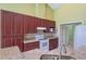 Functional kitchen with dark wood cabinetry, stainless steel appliances, and tile flooring at 5037 Sw 109Th Loop, Ocala, FL 34476
