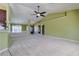 Spacious living room with carpet, neutral walls, and ceiling fan; great for entertaining guests at 5037 Sw 109Th Loop, Ocala, FL 34476